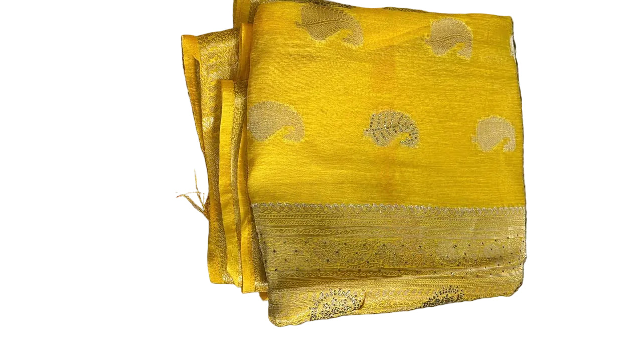 Yellow fabric with gold patterns on a textured surface